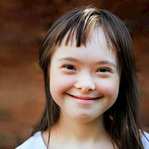 Special needs girl smiling to camera